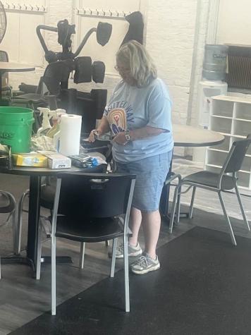 Woman with cleaning supplies on a table 