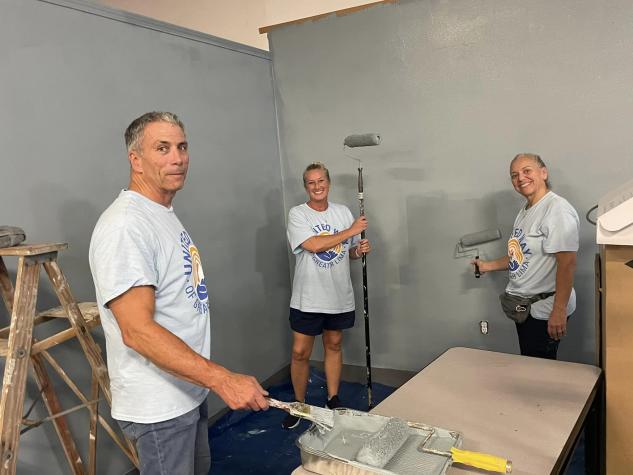 three people painting