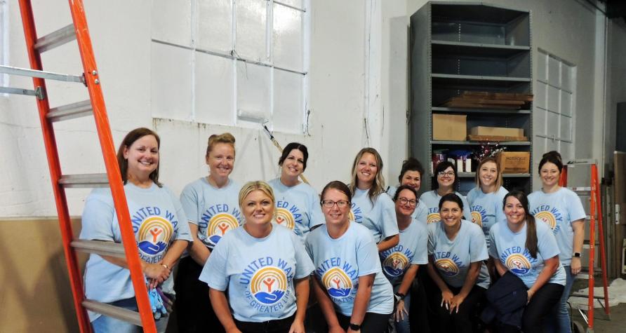 Group of ladies in blue United Way shirts posing for a picture