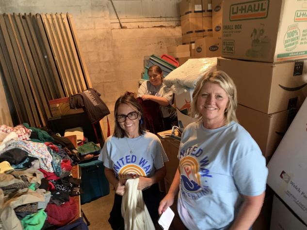 ladies folding clothing for a garage sale