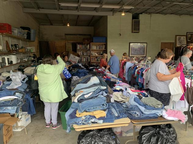 multiple people shopping at a garage sale